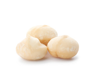 Fototapeta na wymiar Shelled organic Macadamia nuts on white background