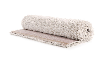 Rolled fuzzy carpet on white background. Interior element