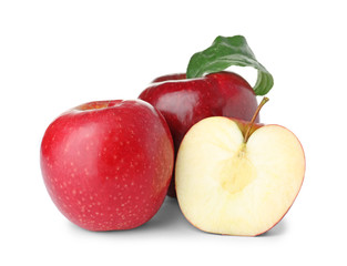 Cut and whole juicy apples on white background