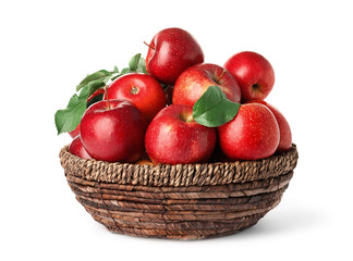 Juicy red apples in wicker basket on white background