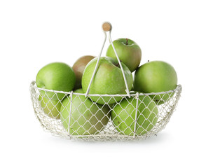 Juicy green apples in metal basket on white background
