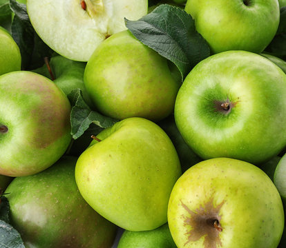 Many ripe juicy green apples as background