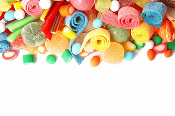 Fototapeta na wymiar Many different yummy candies on white background, top view. Space for text