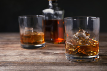 Composition with glass of whiskey on table. Space for text