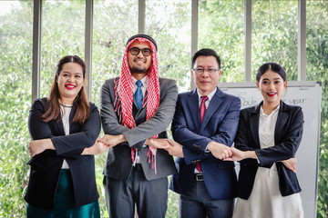 Business meeting Asian team and Arabic man presenting his ideas in office room