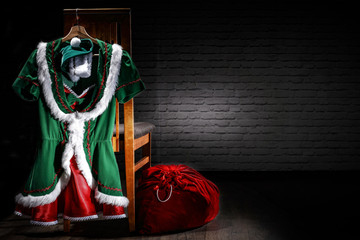 Santa's clothes on a chair before giving away gifts   