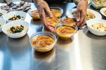 Cook plating their dishes and serving them hot and tasty.