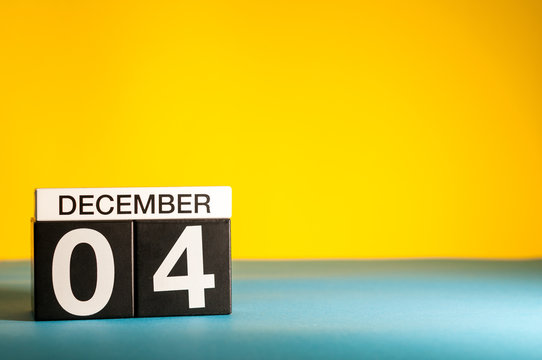 December 4th. Image 4 day of december month, calendar on yellow background. Winter background with empty space for text, mockup