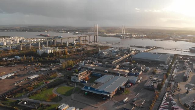 An aerial view of the docks and business near Dartford Crossing tunnel and Queen Elisabeth II bridge at sunset