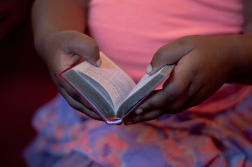 Midsection of woman reading bible in church