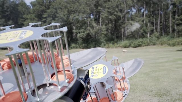 Skeet shooter launching clay targets to be shot