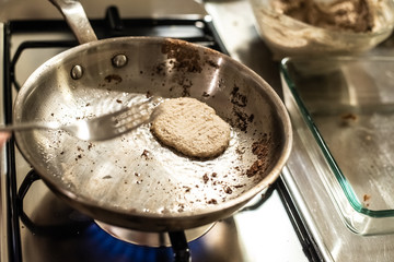 Chef frying a vegan vegetable burger.