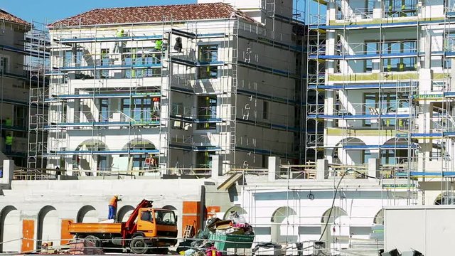 Workers Are Working On An Adaptation Of The Wall Facade Of A Luxury Building