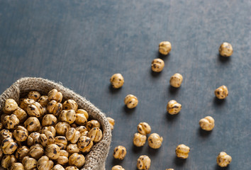 turkish leblebi, famous nut, stack of  yellow roasted chickpea in burlap sack on wooden rustic background, roasted chickpeas
