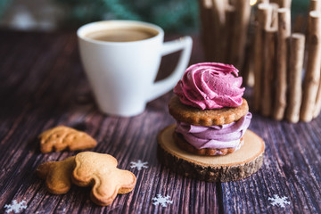 Close up of homemade pink and purple zephyr or marshmallow in powdered sugar with white mug on wooden. Black currant, blueberry marshmallows.