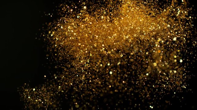 Golden glitter background in super slow motion shooted with high speed cinema camera.