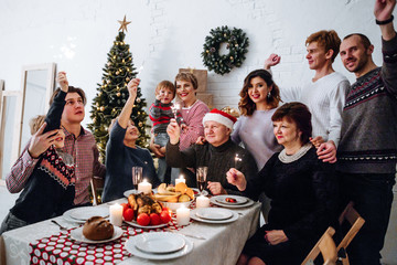 Fototapeta na wymiar Big happy family celebrating Christmas sitting at the table
