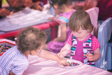 little girl drawing a colorful pictures