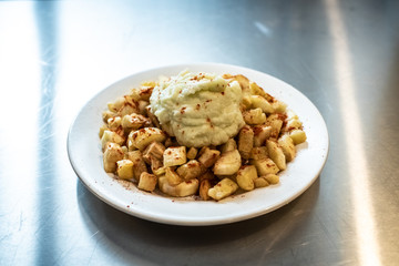 Yuca fried with hummus sauce.