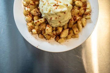 Yuca fried with hummus sauce.