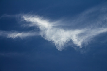 White cloud isolated on neutral blue background. Resource for designers.