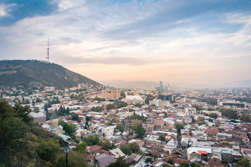 Tbilisi cityscape from a view point in the lights of sunset showing old and modern architecture, Georgia