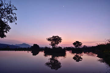 Beautiful scenery sunset sky view of lake and trees reflection in water,Tianxinzi, Sanzhi, New Taipei City, Taiwan        