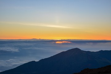 Fototapeta na wymiar Sunrise at the summit of Haleakala volcano on the island of Maui, Hawaii.