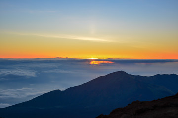 Sunrise at the summit of Haleakala volcano on the island of Maui, Hawaii.