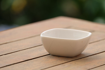 white bowl on wood table.
