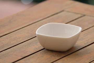 white bowl on wood table.