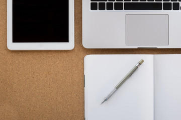 business office wooden desk with laptop, tablet, notebook, pencil, it's necessary equipment for...