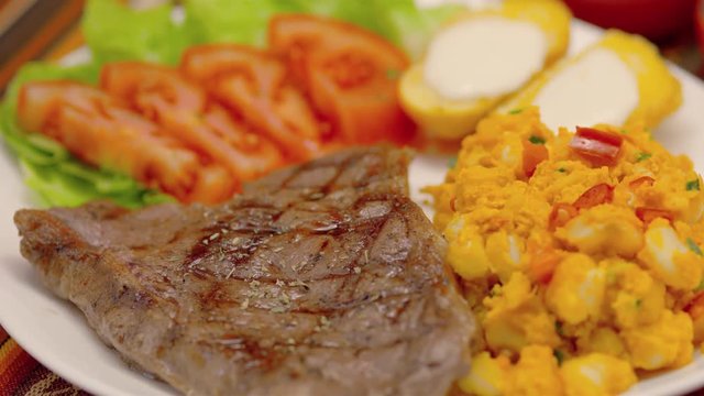 Meat Steak with corn tomatoes, lettuce and potatoes