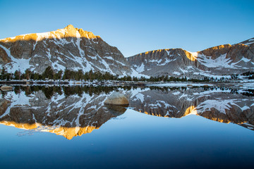 Morning Alpenglow Reflection on a Mountain Lake