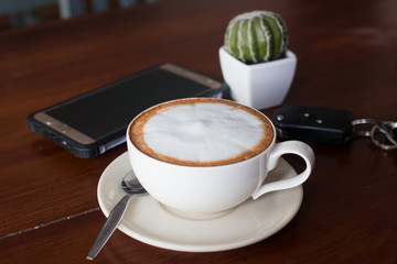 Hot coffee in ceramic glass on wood table
