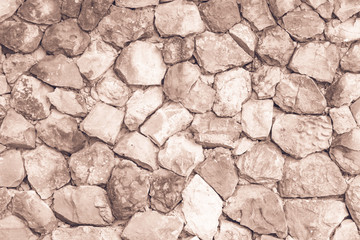 Seamless Brown pattern of decorative cream slate stone wall surface of modern style design decorative uneven cracked realmasonry wall of multicolored stones or blocks with cement or sandstone.