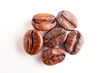 close up of roasted coffee beans isolated on white background