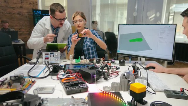 Electronics engineers examining processor