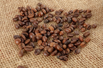 Fototapeta premium Coffee beans on a rug background