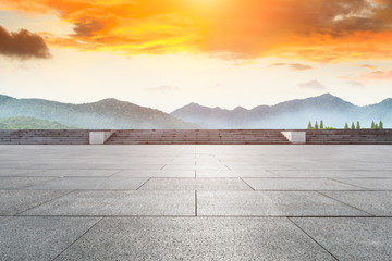 Empty floor and green mountain with beautiful clouds at sunset