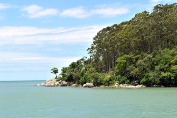 Fototapeta na wymiar Tropical scene with green hill with trees, Atlantic ocean and blue sky