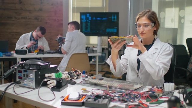 Young female scientist in protective glasses