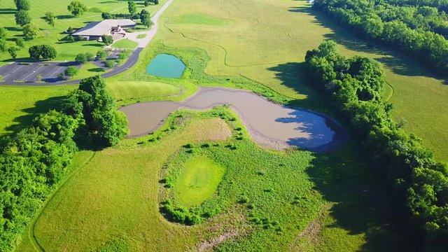 A view of the 2 different color ponds in a field