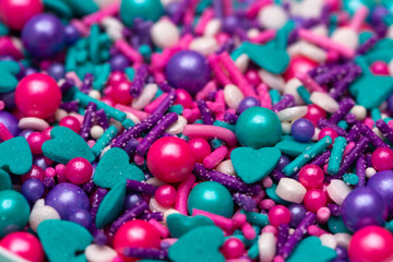 A Background of Mermaid Colored Sprinkles of Various Shapes and Colors
