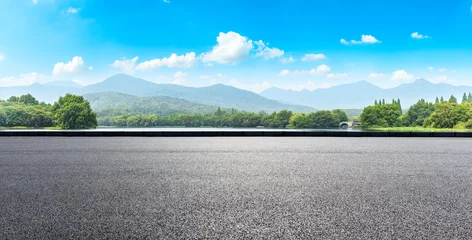 Foto op Plexiglas Asphalt road and mountains with white clouds © ABCDstock