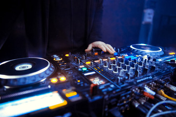 DJ stands before the mixer