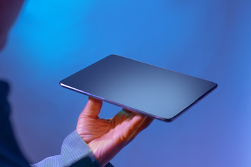 Holding digital tablet with one hand. Digital technology for business and marketing.