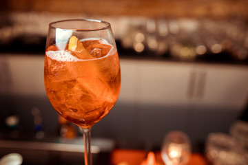 glasses of cocktails on the bar. bartender pours a glass of sparkling wine with Aperol.