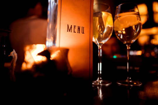 restaurant menu on the background of glasses with wine and candles