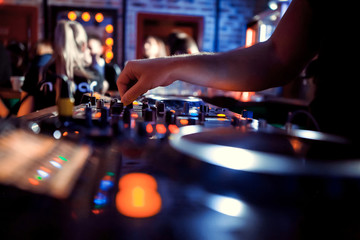 Dj playing disco house progressive electro music at the concert. DJ hands on equipment